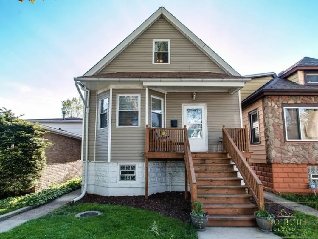 Residential exterior remodel featuring new porch steps, railing, siding, and front entry improvements, Lombard