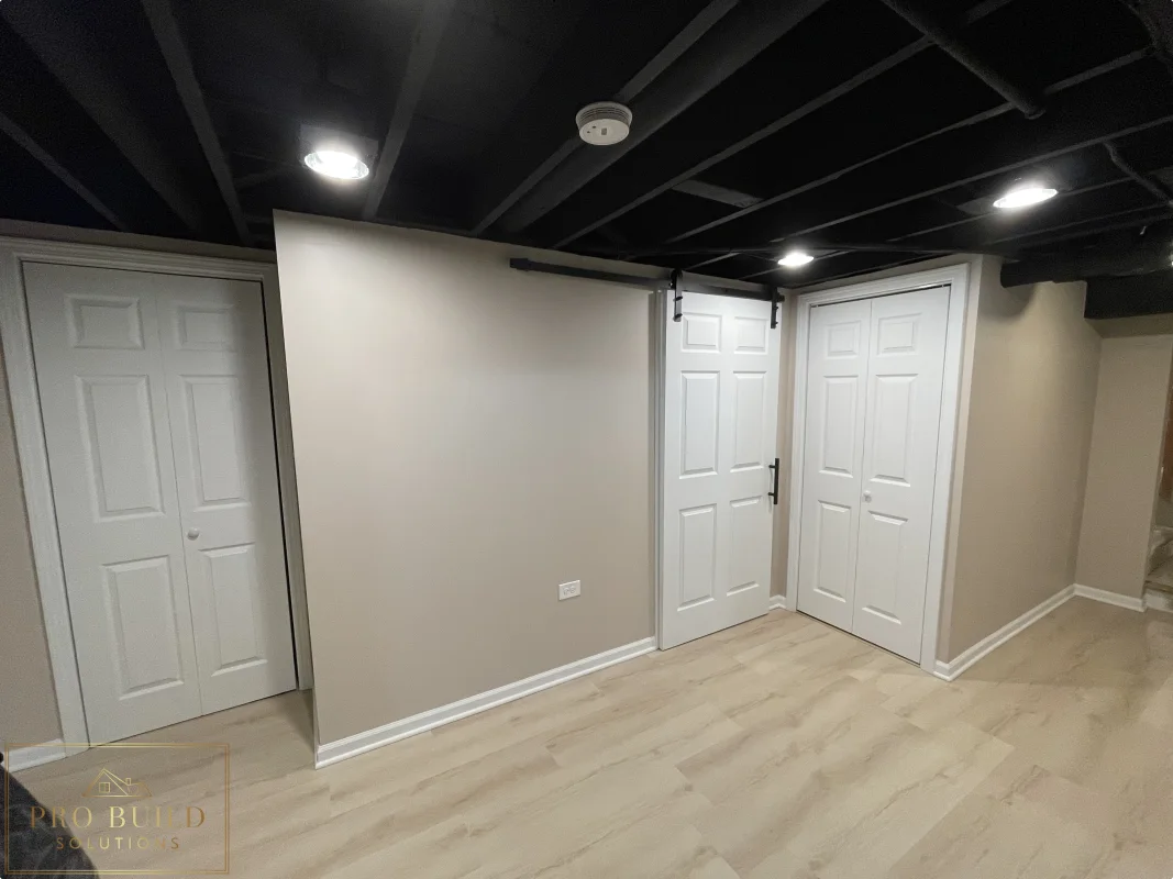 Finished basement Mechanical room featuring neutral walls, painted ceiling beams, closet doors, and updated flooring, Glen Ellyn
