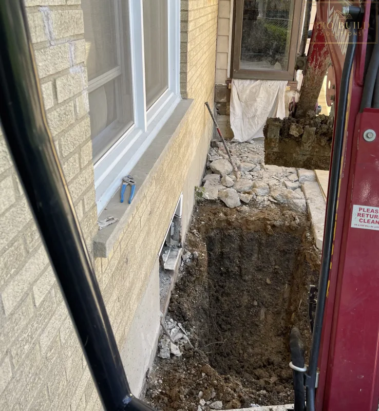 Egress Window area being dug out with excavator, Elmhurst, IL