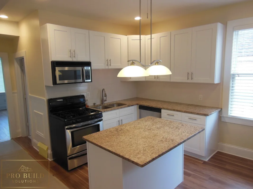 White shaker kitchen remodel with center island, granite countertops, and stainless steel appliances, Lombard, IL