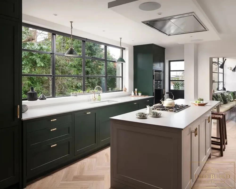 Dark green kitchen with large island, white countertops, black-framed windows, and herringbone wood flooring, Glenview, IL