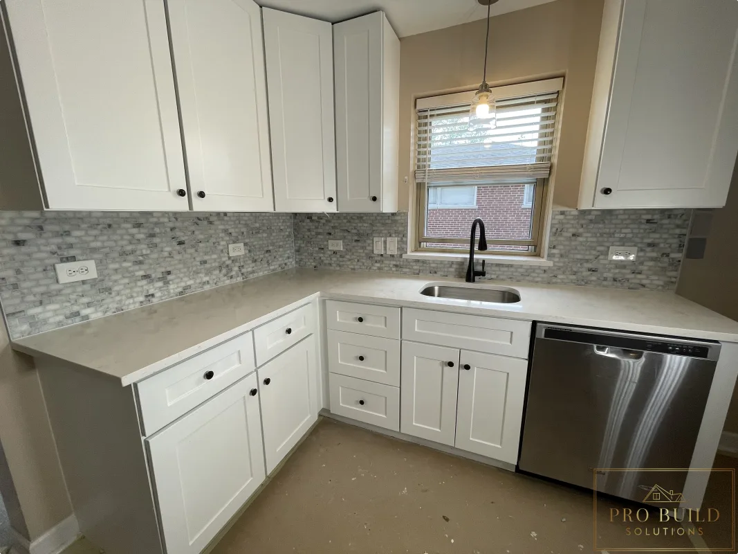 Small residential kitchen renovation with white shaker cabinetry, undermount sink, and modern black faucet, Bartlett, IL