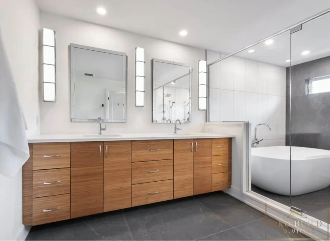 Contemporary spa-style bathroom featuring warm wood cabinetry, dual mirrors, glass-enclosed shower, and sleek tub design, Hinsdale, IL