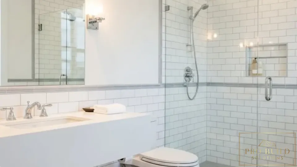 Clean traditional bathroom design featuring a glass walk-in shower, white tile walls, and timeless neutral finishes, Addison