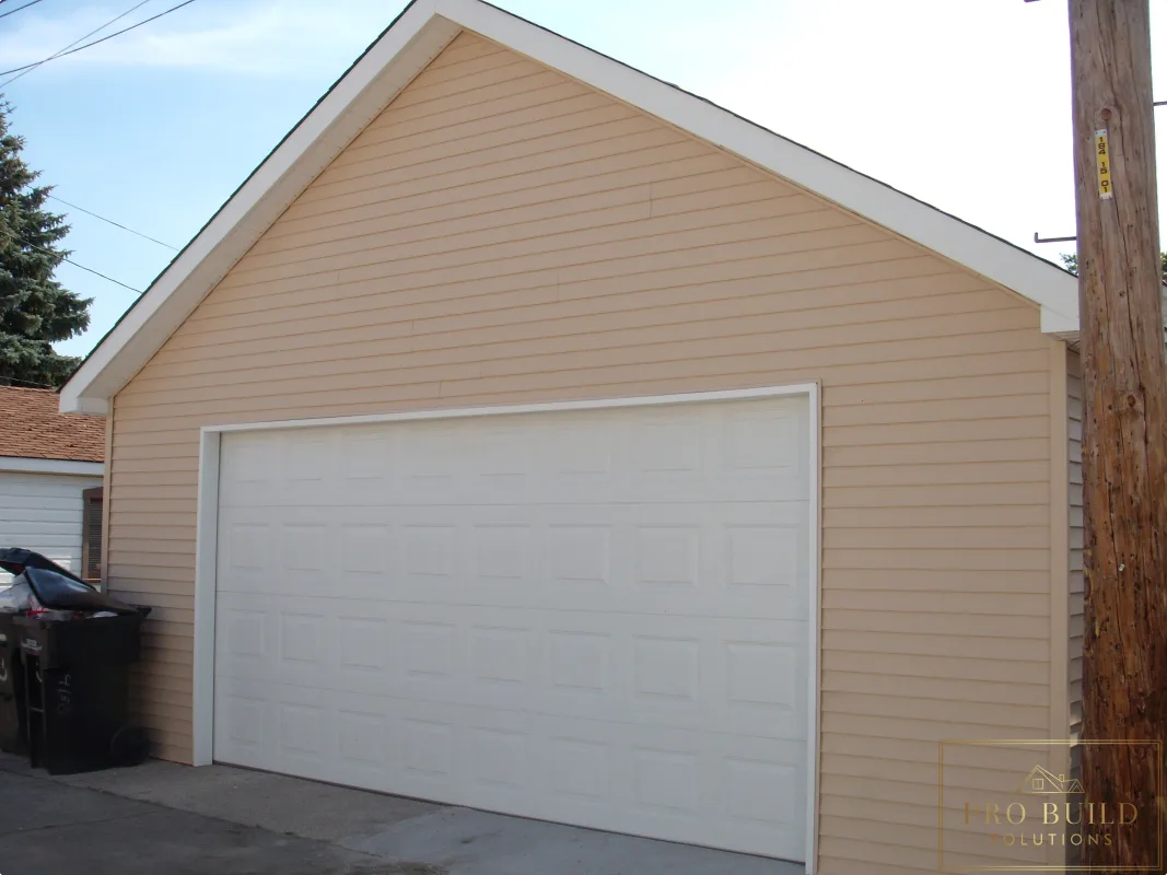Detached garage improvement with new siding, garage door installation, and finished roofline details, Chicago