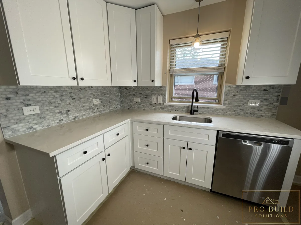 Small residential kitchen renovation with white shaker cabinetry, undermount sink, and modern black faucet, Bartlett, IL