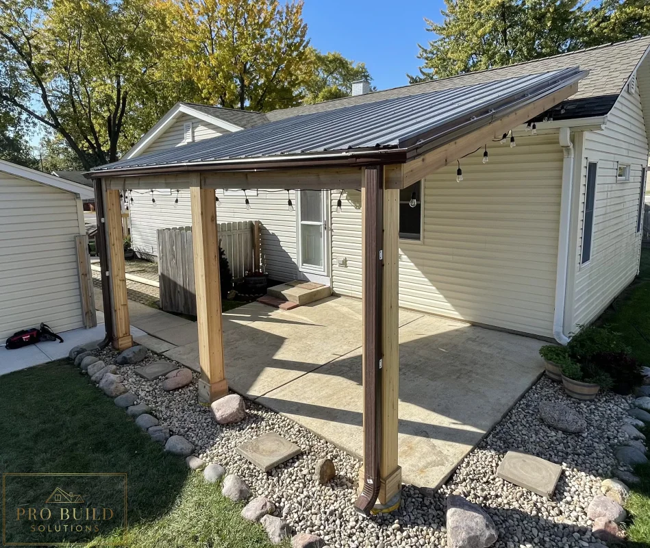 Wood-framed patio roof extension creating a shaded outdoor seating area in a residential yard, Rolling Meadows, IL