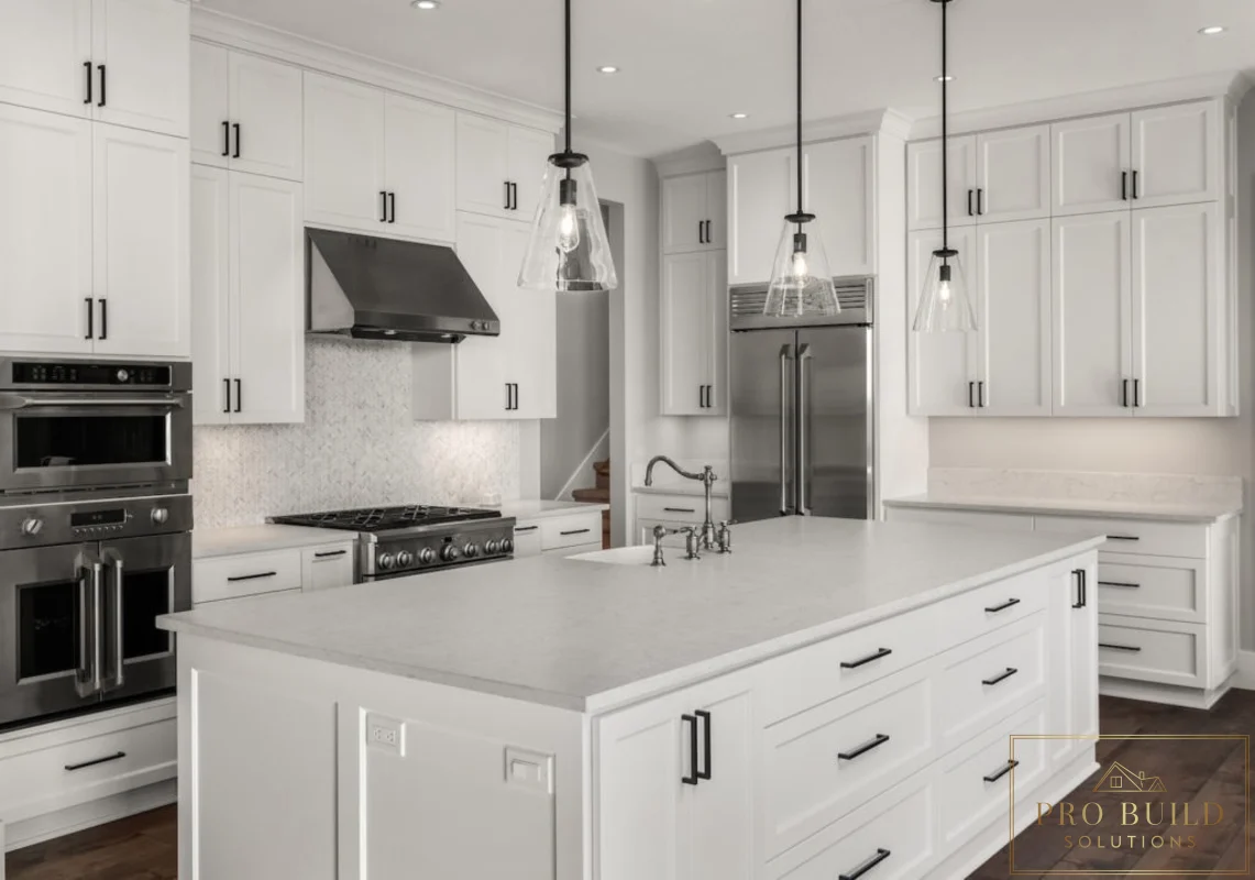Traditional all-white kitchen with oversized island, stainless appliances, glass pendant lights, and dark wood flooring, Wheaton, IL