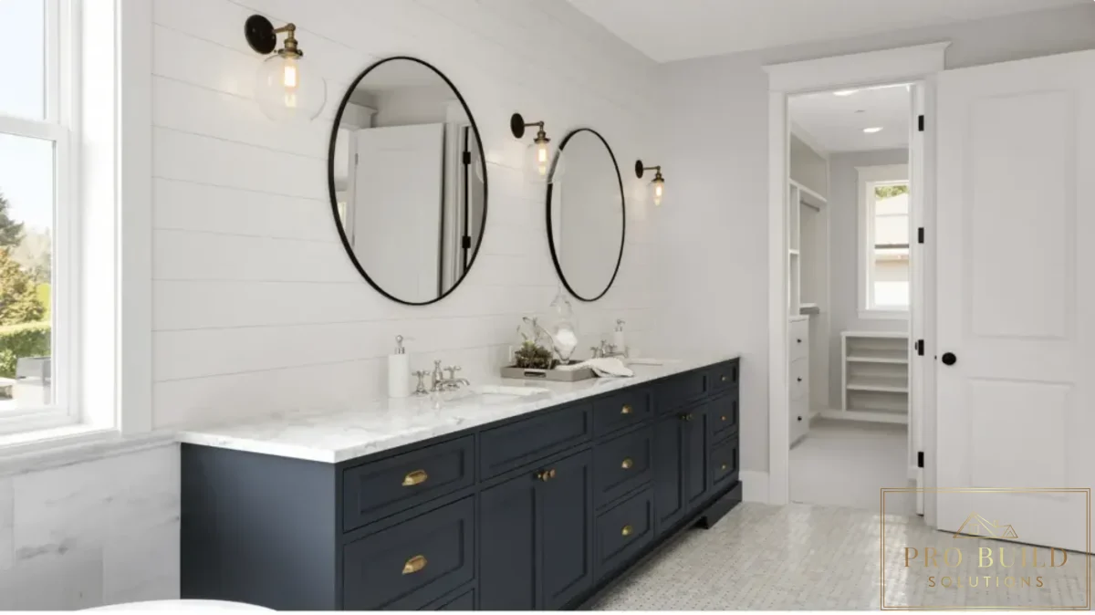 Timeless traditional bathroom design featuring a dark blue vanity, dual sinks, shiplap wall detail, and classic sconces, Itasca