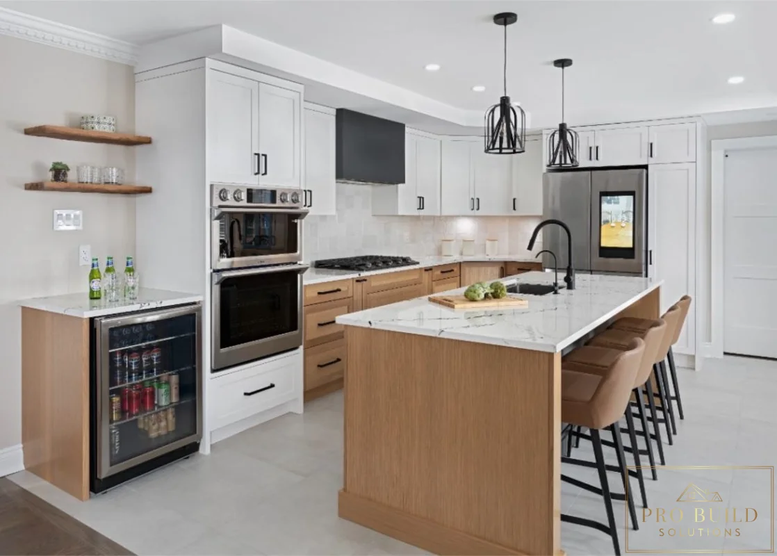 Spacious kitchen remodel with white perimeter cabinetry, warm wood island, built-in beverage fridge, and waterfall-style seating area, Carol Stream