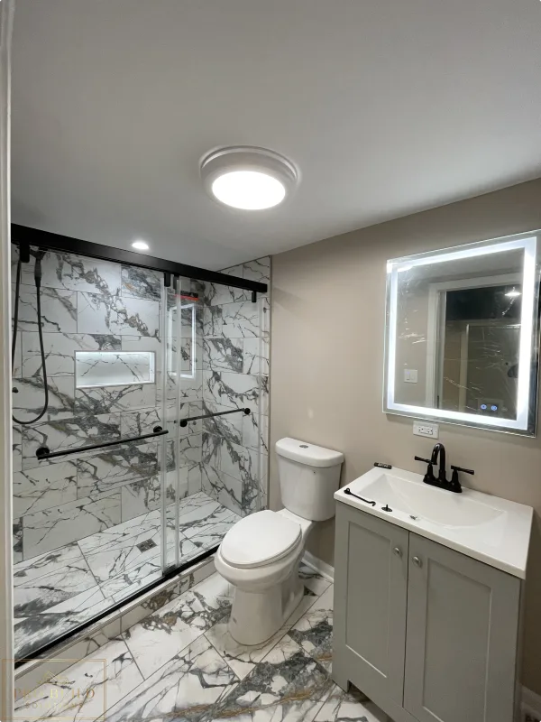 Small bathroom remodel with walk-in shower, marble-look tile, updated vanity, and neutral wall finishes, Itasca