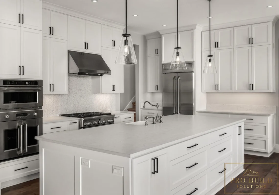 Traditional all-white kitchen with oversized island, stainless appliances, glass pendant lights, and dark wood flooring, Wheaton, IL