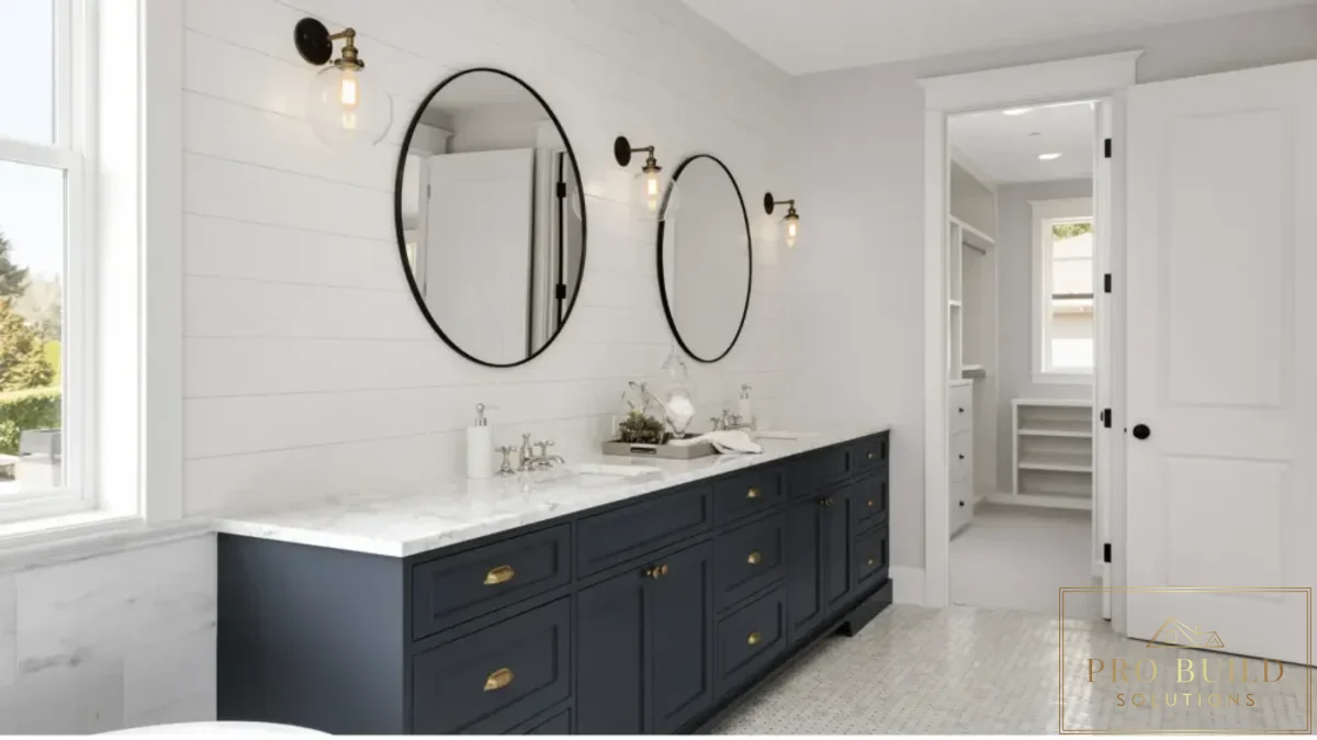 Timeless traditional bathroom design featuring a dark blue vanity, dual sinks, shiplap wall detail, and classic sconces, Itasca
