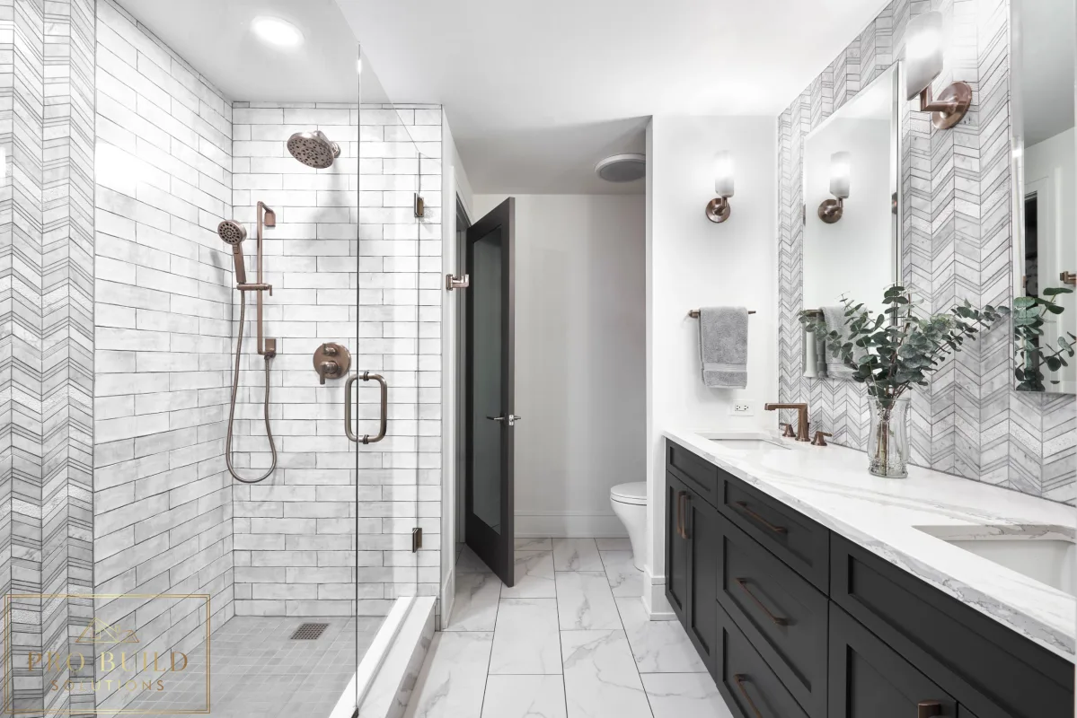 Stylish transitional bathroom design featuring black cabinetry, patterned wall tile, and a frameless walk-in shower, Riverside