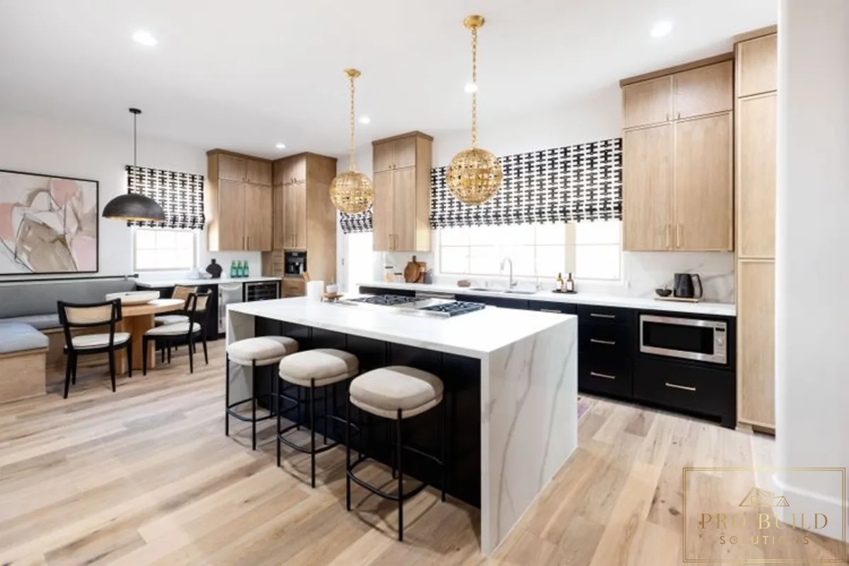 Modern kitchen with light wood and black cabinetry, waterfall island, globe pendant lights, and clean open layout, Lemont, IL