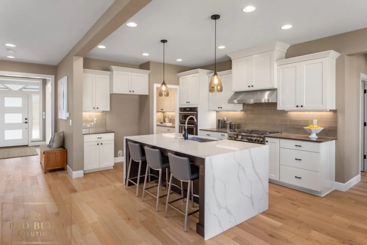 Elegant white kitchen featuring classic cabinetry, quartz island seating, pendant lighting, and soft neutral finishes, Bartlett, IL