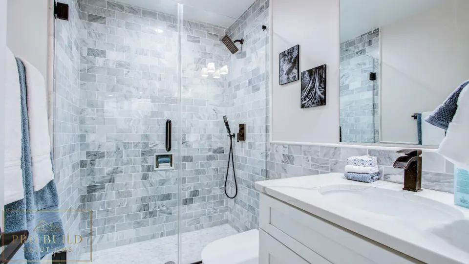 Classic bathroom renovation featuring a frameless glass shower, white cabinet vanity, and gray marble tile surround, Wood Dale