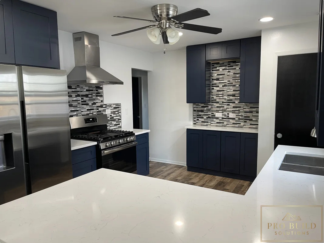 Kitchen remodel with navy cabinets, patterned mosaic backsplash, recessed lighting, and stainless steel finishes, Lemont, IL