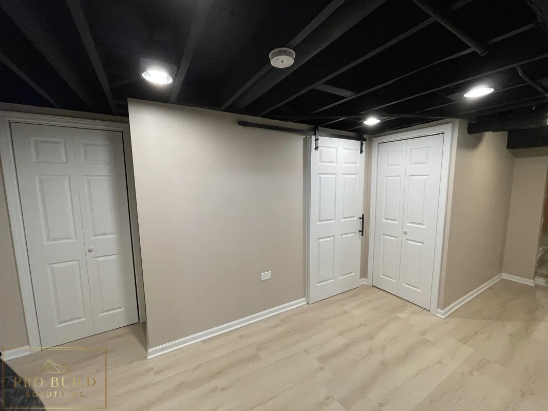Finished basement Mechanical room featuring neutral walls, painted ceiling beams, closet doors, and updated flooring, Glen Ellyn