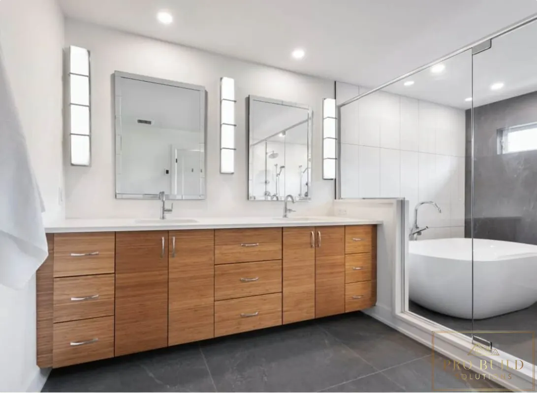 Contemporary spa-style bathroom featuring warm wood cabinetry, dual mirrors, glass-enclosed shower, and sleek tub design, Hinsdale, IL