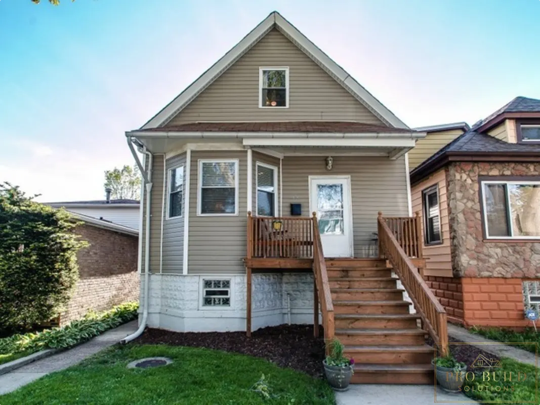 Residential exterior remodel featuring new porch steps, railing, siding, and front entry improvements, Lombard
