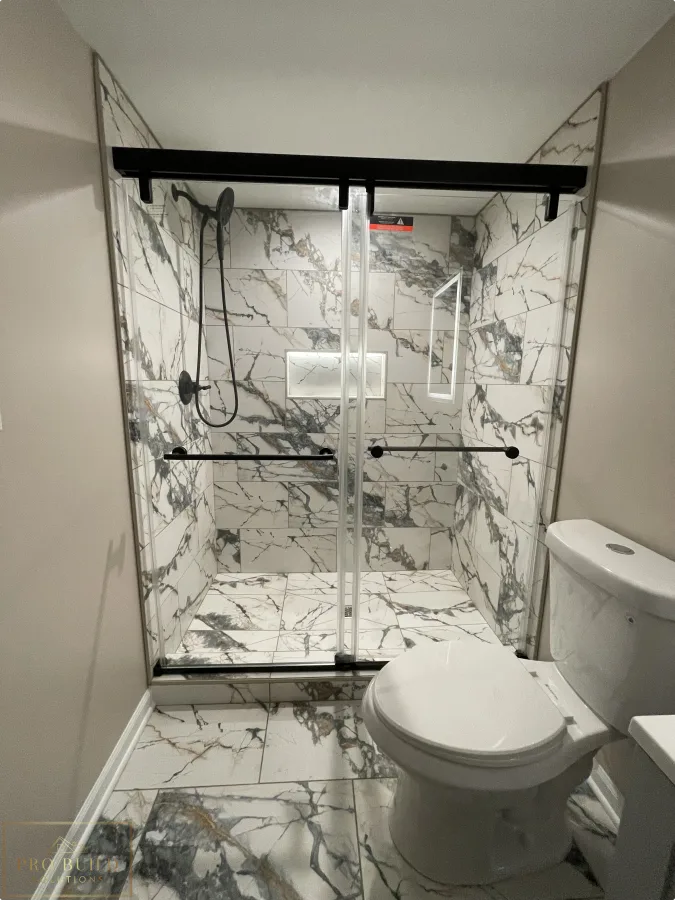 Small bathroom remodel with walk-in shower, marble-look tile, updated vanity, and neutral wall finishes, Itasca