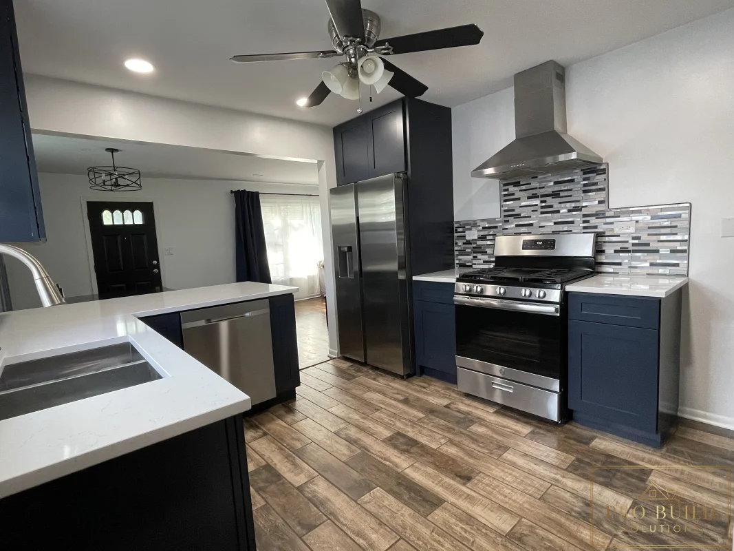 6*24 Ceramic Flooring, New Stainless Steel Appliances, Stainless Steel Exhaust Hood, Mosaic Backsplash Over White Granite Countertops sitting on Navy Soft Close Cabinets. New Can Lights. Creating an Open Kitchen Concept, La Grange, IL