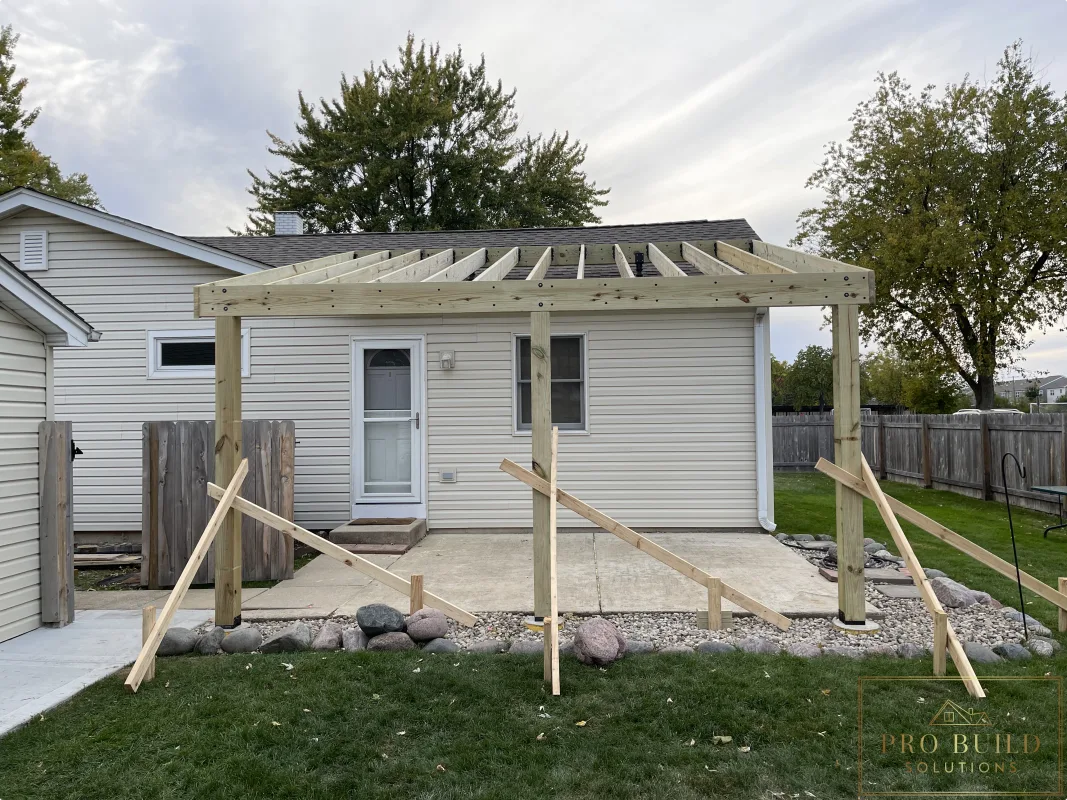 Framing stage of custom covered pergola with SkyLift roof risers and pressure-treated lumber, Rolling Meadows, IL