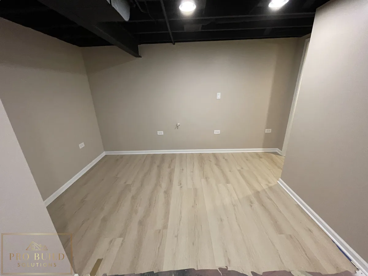Small finished basement room with light wood-look flooring, neutral walls, black ceiling, and recessed lighting, Crest Hill