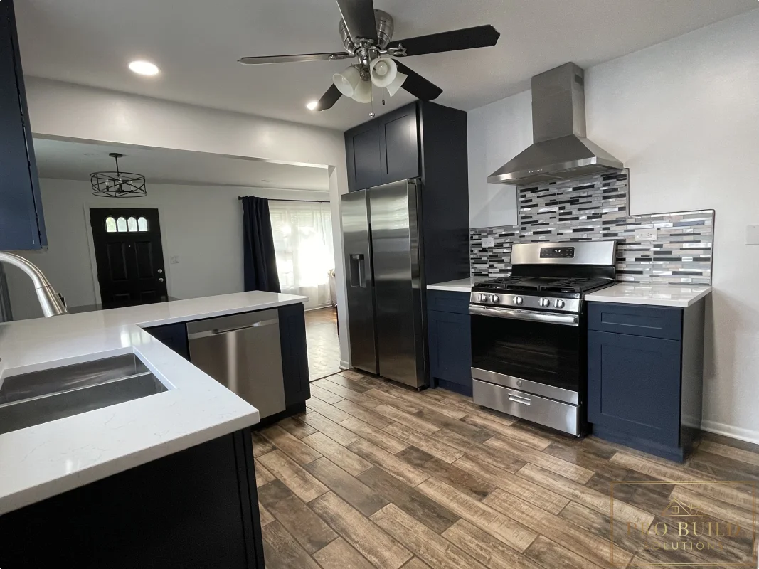 6*24 Ceramic Flooring, New Stainless Steel Appliances, Stainless Steel Exhaust Hood, Mosaic Backsplash Over White Granite Countertops sitting on Navy Soft Close Cabinets. New Can Lights. Creating an Open Kitchen Concept, La Grange, IL