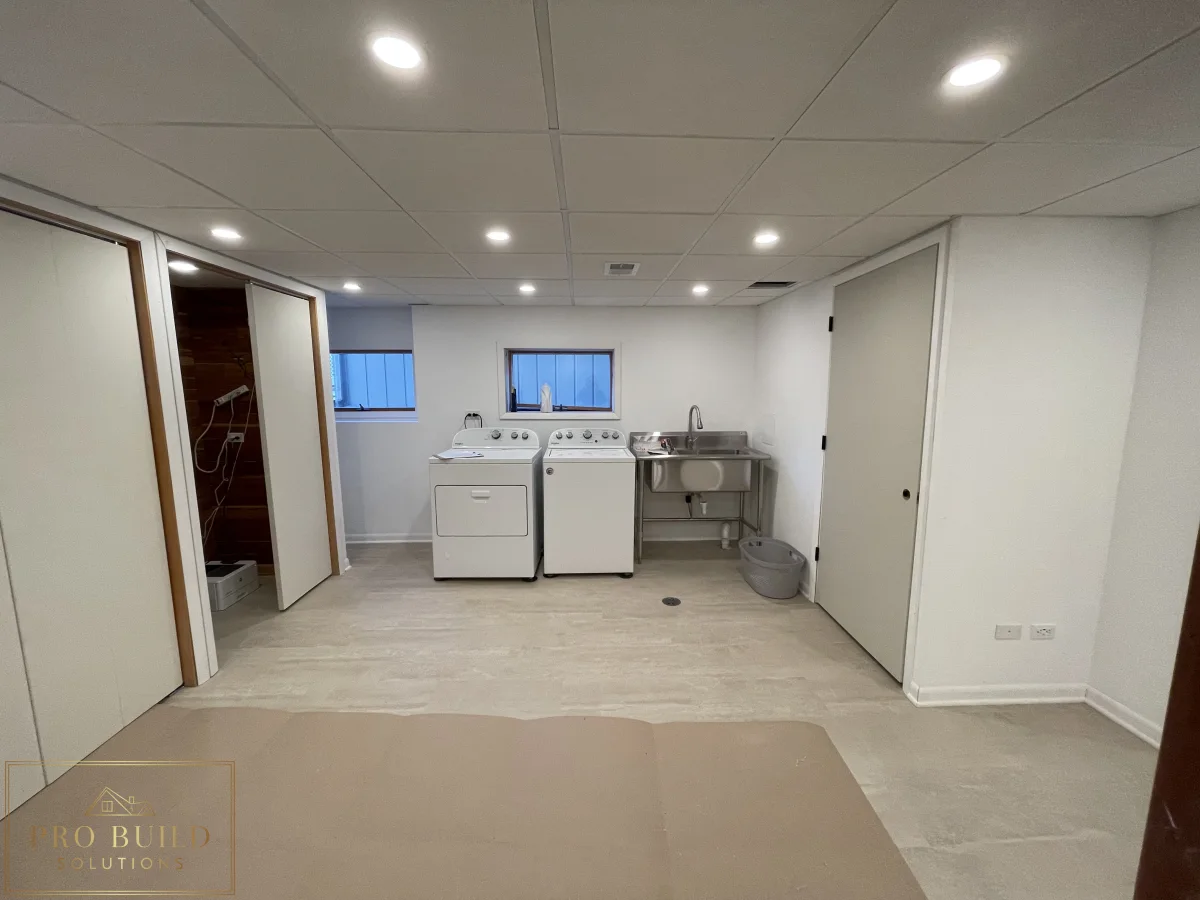 Finished basement remodel with laundry area, utility sink, recessed lighting, and light wood-look flooring, Western Springs