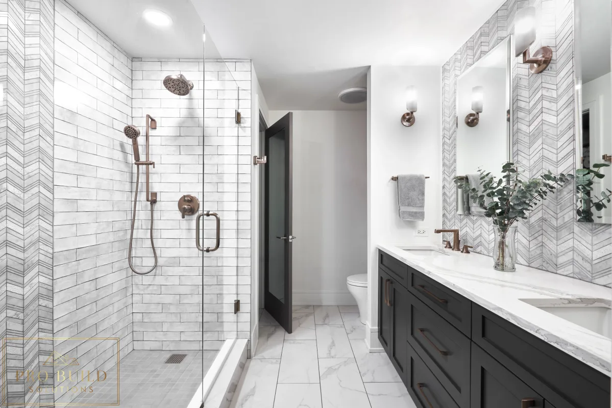 Stylish transitional bathroom design featuring black cabinetry, patterned wall tile, and a frameless walk-in shower, Riverside