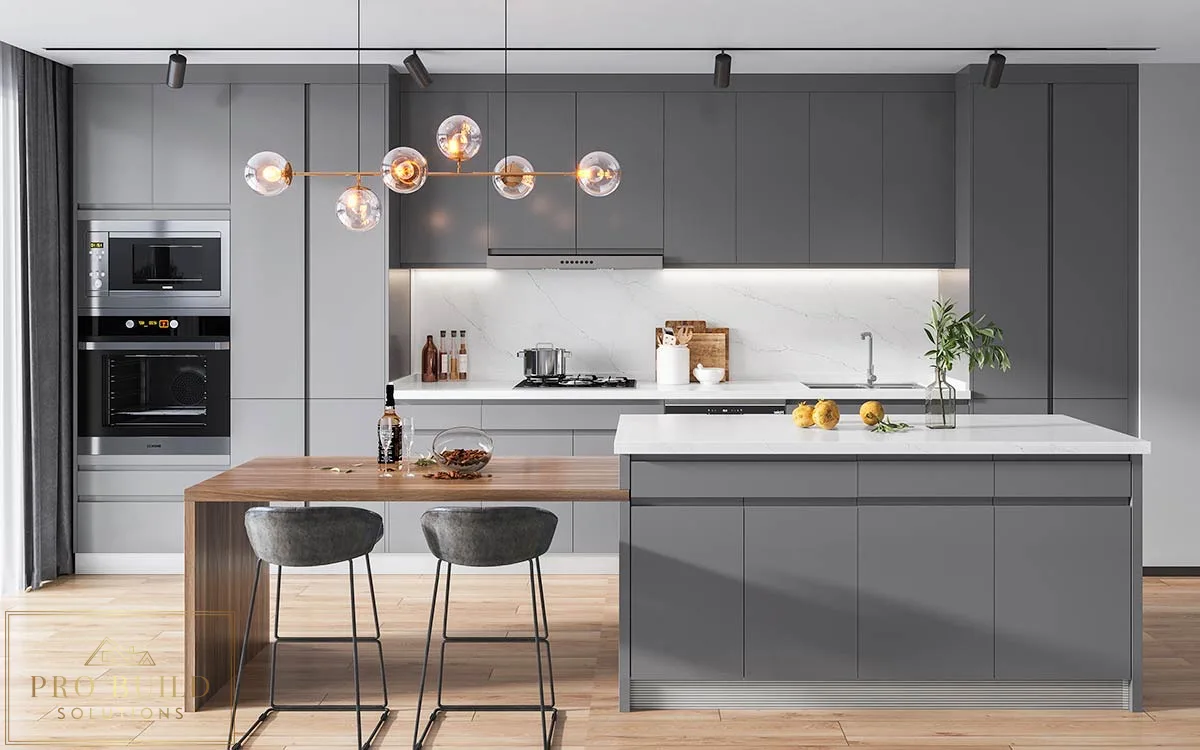 Sleek gray modern kitchen featuring handleless-style cabinets, waterfall island, built-in ovens, and contemporary globe chandelier, Lisle