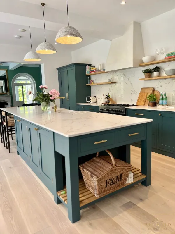 Elegant classic kitchen featuring teal cabinets, statement island, warm wood details, and light natural flooring, Lombard