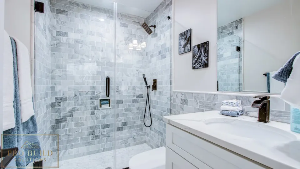 Classic bathroom renovation featuring a frameless glass shower, white cabinet vanity, and gray marble tile surround, Wood Dale
