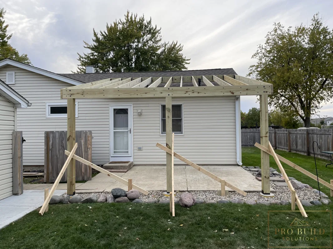 Framing stage of custom covered pergola with SkyLift roof risers and pressure-treated lumber, Rolling Meadows, IL
