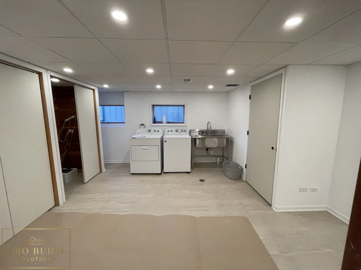 Basement remodel with laundry setup, updated flooring, drop ceiling panels, and bright recessed lighting, Western Springs
