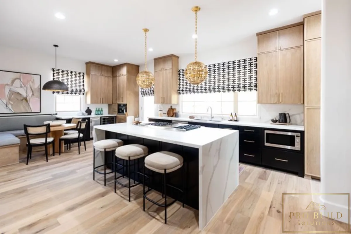 Modern kitchen with light wood and black cabinetry, waterfall island, globe pendant lights, and clean open layout, Lemont, IL