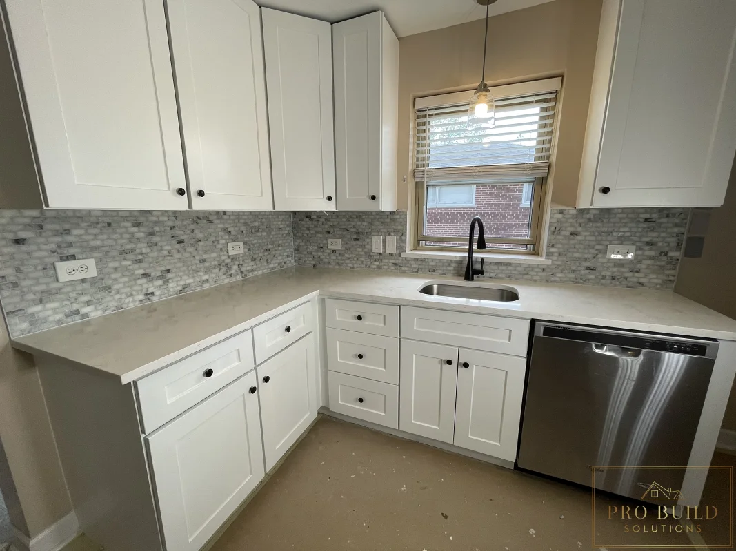 Small residential kitchen renovation with white shaker cabinetry, undermount sink, and modern black faucet, Bartlett, IL