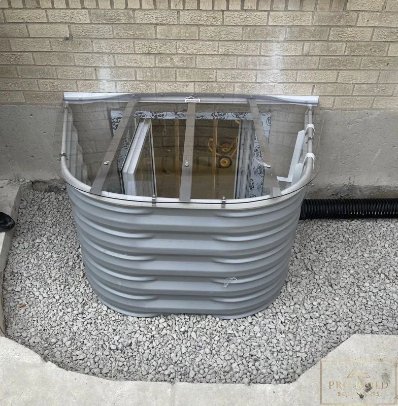 Completed Egress 24"w * 48"h with Window Well Cover backfilled with gravel before Concrete finish, Elmhurst