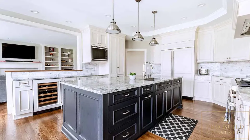 Traditional white kitchen with dark wood island, marble countertops, custom cabinetry, and built-in wine storage, Arlington Heights