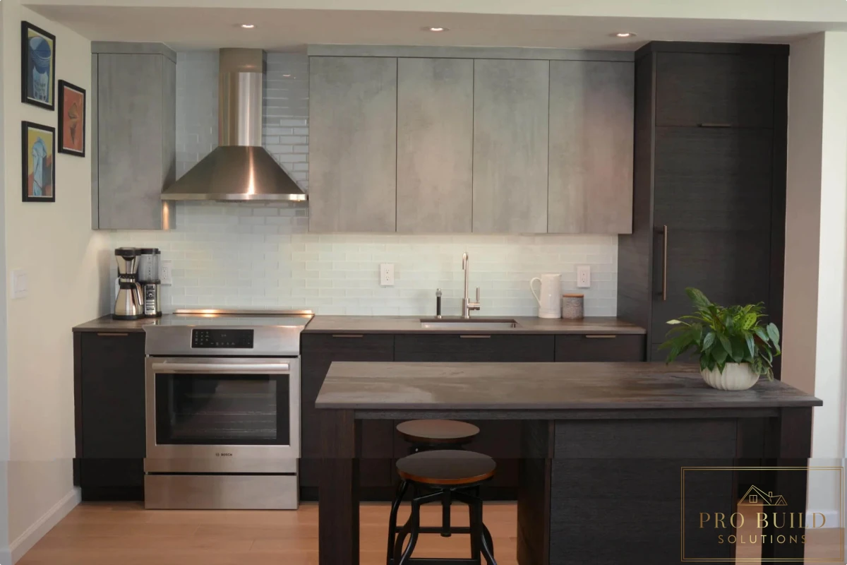 Modern kitchen with dark lower cabinets, light gray upper cabinets, white subway tile backsplash, and minimalist island seating, Downers Grove