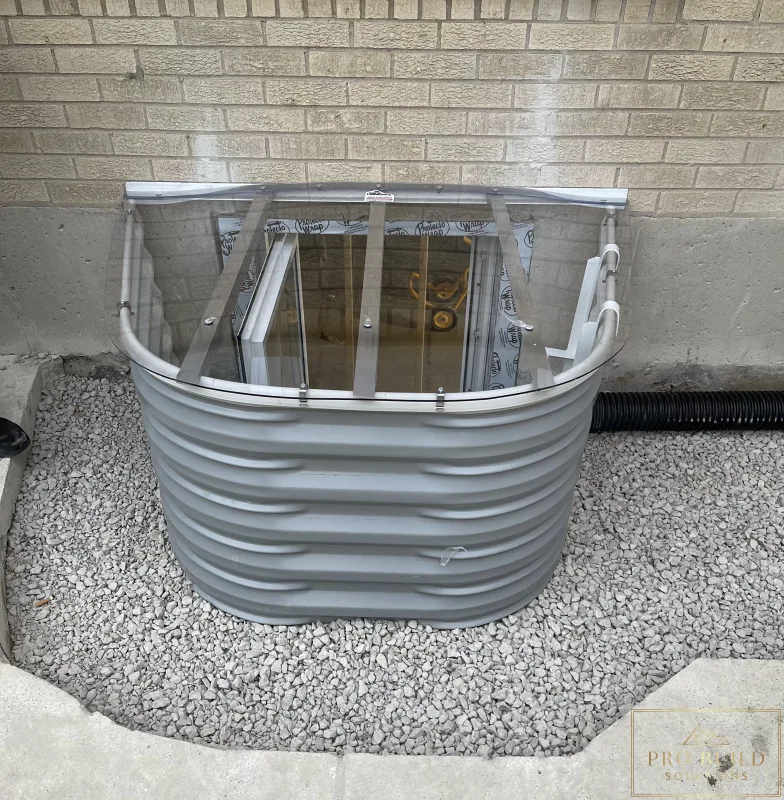 Completed Egress 24"w * 48"h with Window Well Cover backfilled with gravel before Concrete finish, Elmhurst