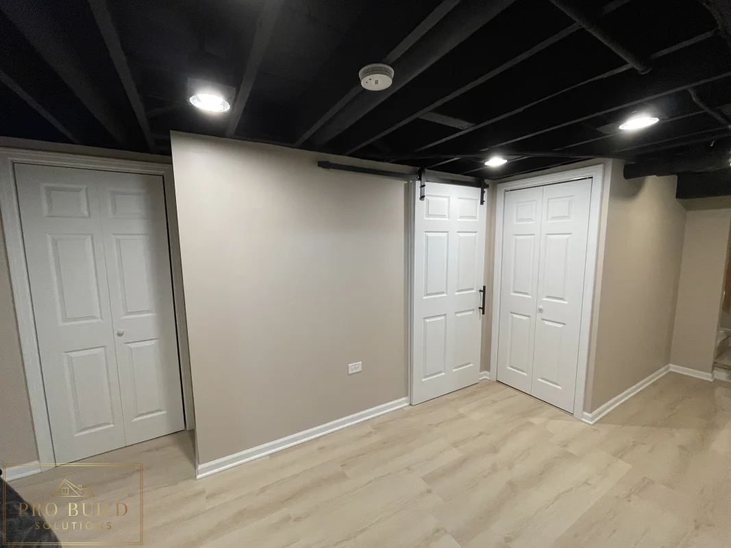 Finished basement Mechanical room featuring neutral walls, painted ceiling beams, closet doors, and updated flooring, Glen Ellyn