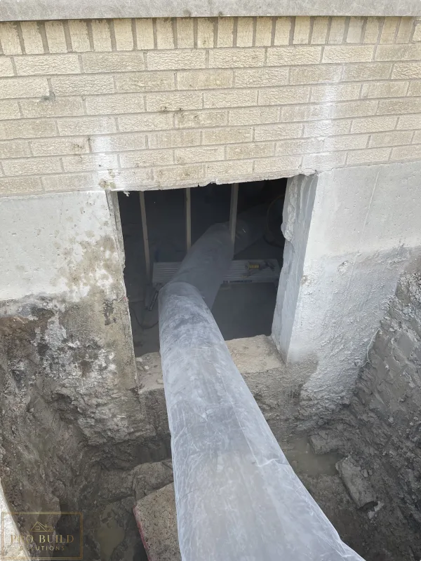 Egress window area trenched to the bottom of the foundation for proper drainage, creating proper ventilation in place while cutting the 24"w * 48"h opening for the window., Elmhurst