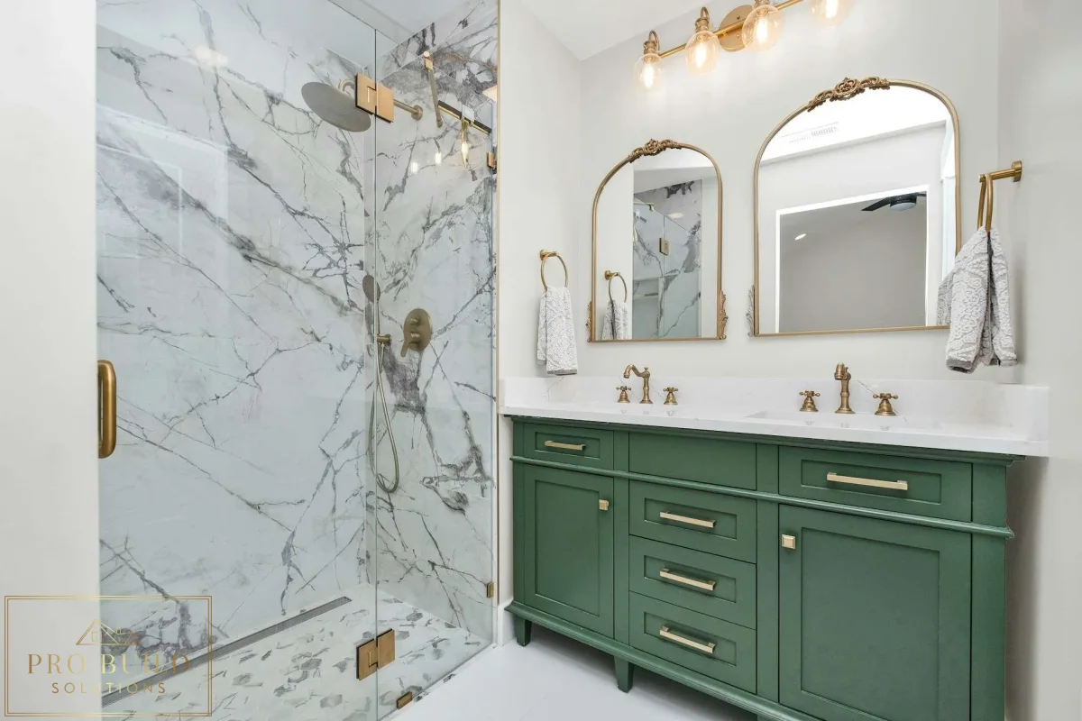 Elegant traditional bathroom design featuring a custom green vanity, frameless marble shower, and warm brass hardware, Elmhurst, IL