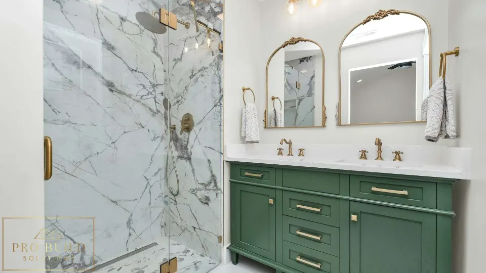 Elegant traditional bathroom design featuring a custom green vanity, frameless marble shower, and warm brass hardware, Elmhurst, IL