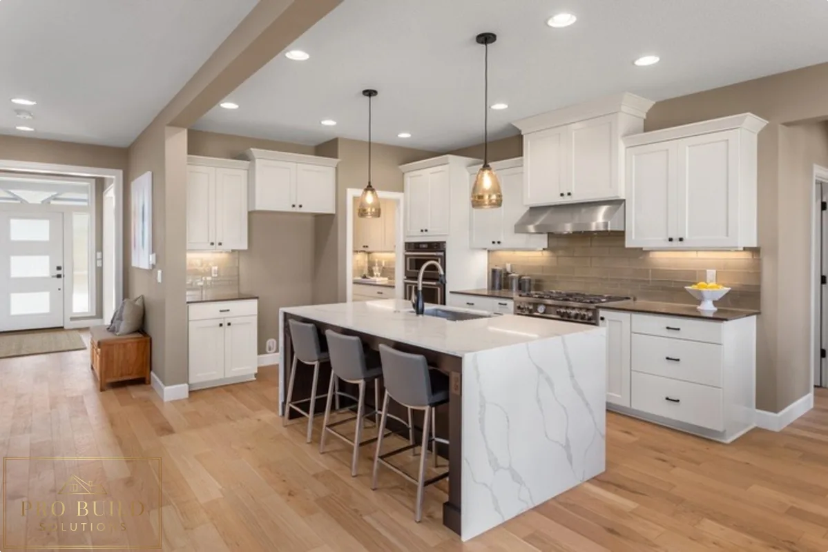 Elegant white kitchen featuring classic cabinetry, quartz island seating, pendant lighting, and soft neutral finishes, Bartlett, IL