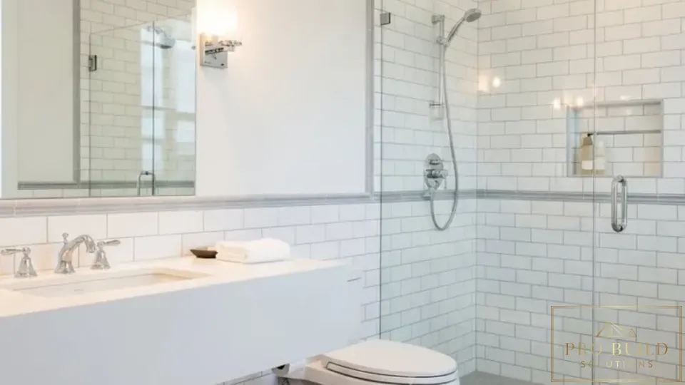 Clean traditional bathroom design featuring a glass walk-in shower, white tile walls, and timeless neutral finishes, Addison