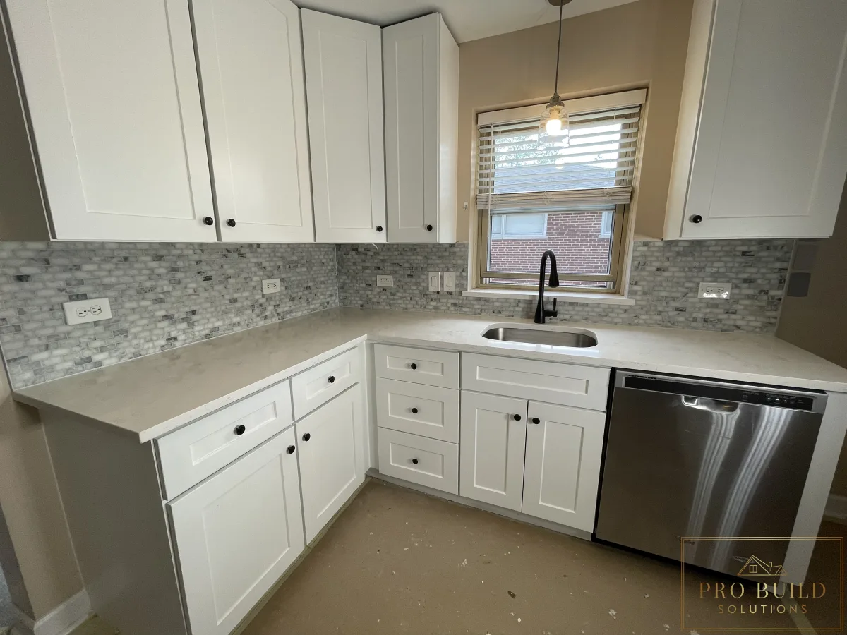 Small residential kitchen renovation with white shaker cabinetry, undermount sink, and modern black faucet, Bartlett, IL